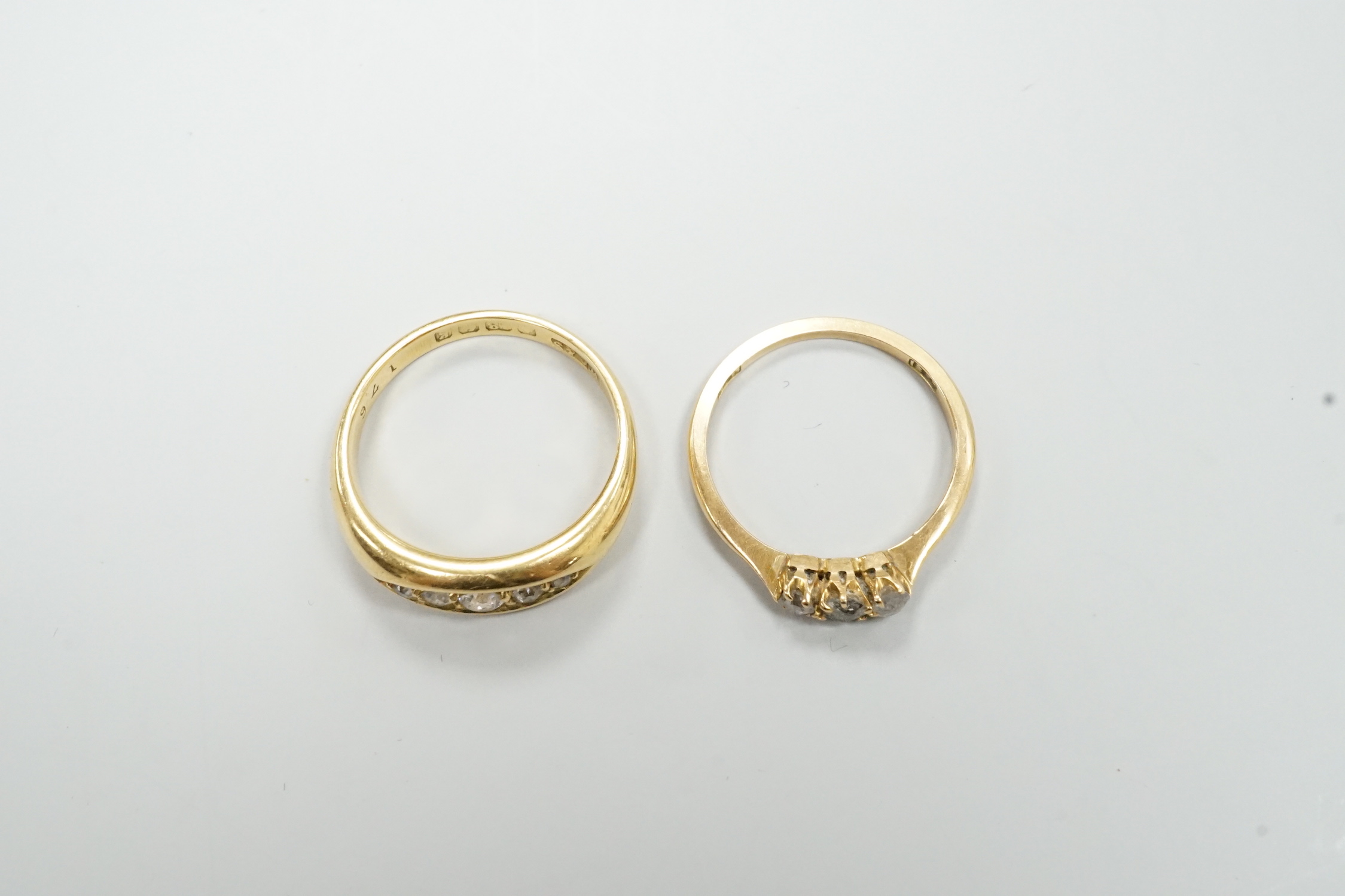 An Edwardian 18ct gold and graduated five stone diamond chip set ring, size P/Q and a small 18ct and three stone diamond ring, gross weight 7.3 grams.